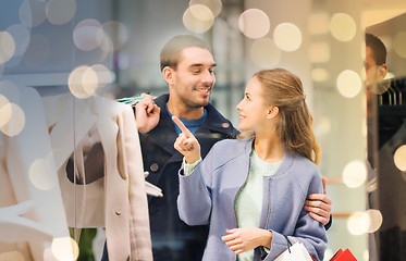 Image showing happy young couple with shopping bags in mall