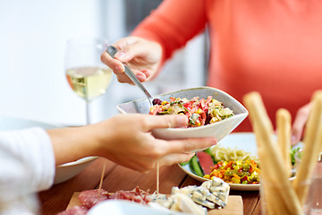 Image showing people eating salad at table with food