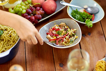 Image showing people eating salad at table with food