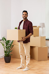 Image showing happy man with box moving to new home and dancing