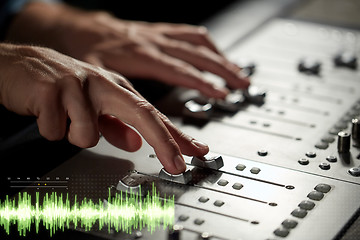 Image showing hands on mixing console at sound recording studio