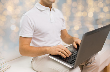 Image showing close up of man typing on laptop keyboard