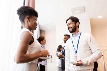 Image showing business people with conference badges and coffee