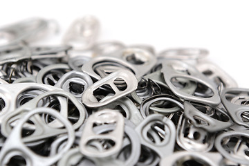 Image showing Heap of ring pulls with one pull tab in focus