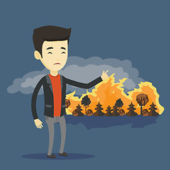 Image showing Man standing on the background of wildfire.