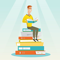 Image showing Student sitting on huge pile of books.