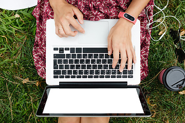 Image showing Crop top view of woman using laptop