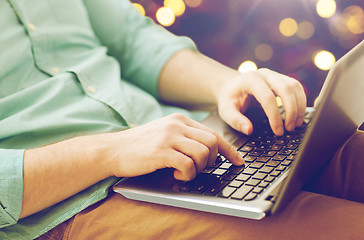 Image showing close up of man typing on laptop keyboard