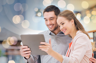 Image showing happy couple with tablet pc taking selfie in mall