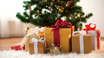 Image showing gift boxes on sheepskin at christmas tree