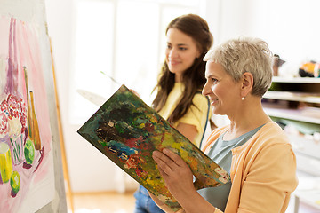 Image showing happy women painting at art school studio