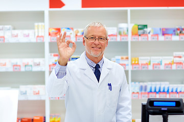 Image showing senior apothecary at pharmacy showing ok hand sign