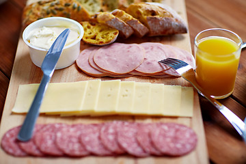 Image showing cream cheese and other food on table at breakfast