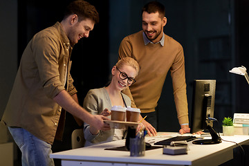 Image showing business team with computer working late at office