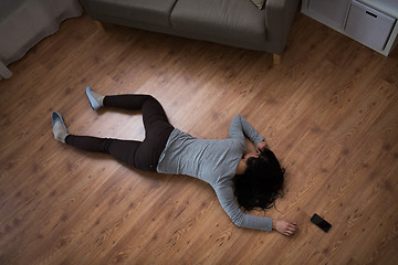 Image showing dead woman body lying on floor at crime scene