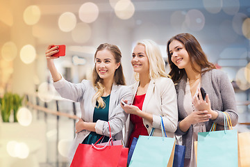 Image showing women with smartphones shopping and taking selfie