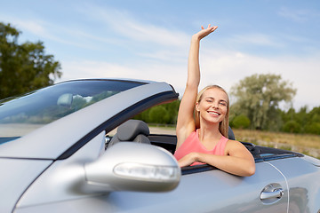 Image showing happy young woman in convertible car