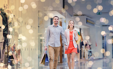 Image showing happy young couple with shopping bags in mall