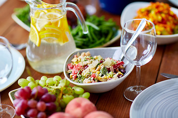 Image showing vegetable salad in bowl and other food on table