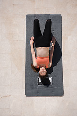 Image showing woman doing morning yoga exercises top view