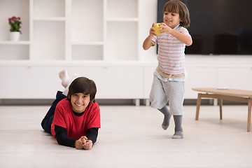 Image showing boys having fun with an apple on the floor