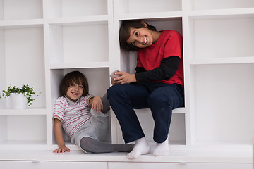 Image showing young boys posing on a shelf