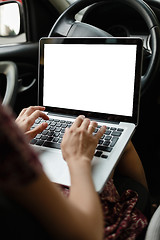 Image showing Anonymous woman browsing laptop in car