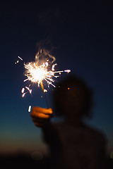 Image showing Anonymous person with burning firework