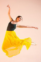 Image showing Young and incredibly beautiful ballerina is dancing at studio