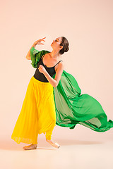 Image showing Young and incredibly beautiful ballerina is dancing at studio