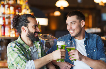 Image showing male friends drinking green beer at bar or pub