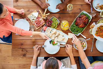 Image showing group of people eating at table with food