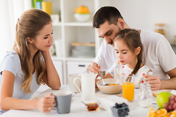 Image showing happy family having breakfast at home