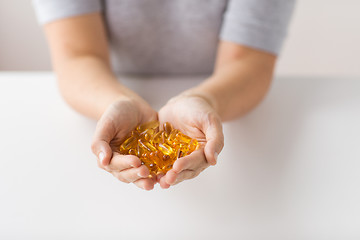 Image showing hands holding cod liver oil capsules