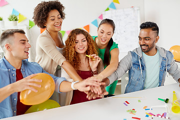 Image showing happy business team at office party holding hands