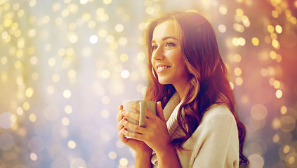Image showing happy woman with cup of tea or coffee at home