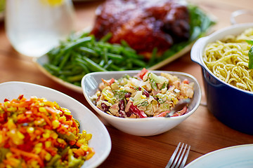 Image showing vegetable salad in bowl and other food on table