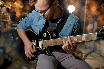 Image showing man playing guitar at studio or concert 