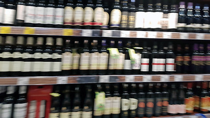 Image showing Blurred wine bottles on shelf