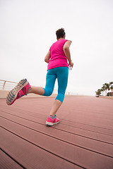 Image showing woman busy running on the promenade