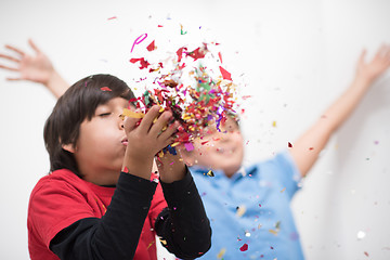 Image showing kids  blowing confetti