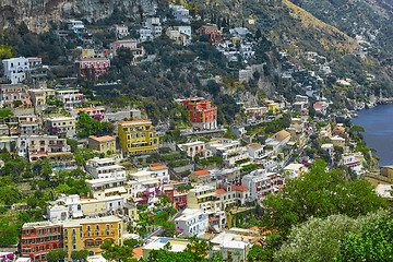 Image showing One of the best resorts of Italy with old colorful villas on the steep slope, nice beach, numerous yachts and boats in harbor and medieval towers along the coast, Positano.