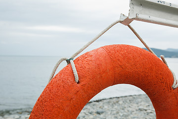 Image showing orange lifebuoy on the sea coast