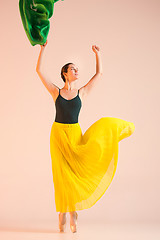 Image showing Young and incredibly beautiful ballerina is dancing at studio