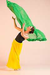 Image showing Young and incredibly beautiful ballerina is dancing at studio