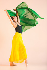 Image showing Young and incredibly beautiful ballerina is dancing at studio