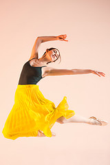 Image showing Young and incredibly beautiful ballerina is dancing at studio