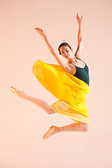 Image showing Young and incredibly beautiful ballerina is dancing at studio