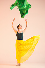 Image showing Young and incredibly beautiful ballerina is dancing at studio