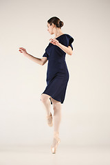 Image showing Young and incredibly beautiful ballerina is dancing in a blue studio